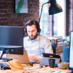 selective-focus-photo-of-man-in-official-shirt-sitting-in-2451645
